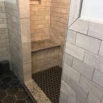 Beautiful custom shower tiled in shades of grey and black